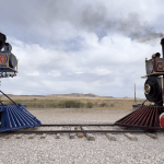steam locomoties facing off at Promitory POint in Utah where the golden spike was laid connected America